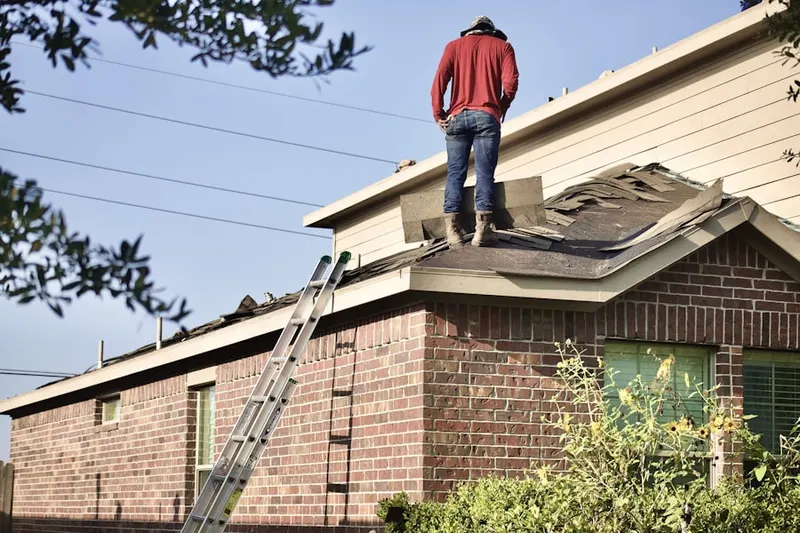 Professional roofer working on a residential roof in White Oak East